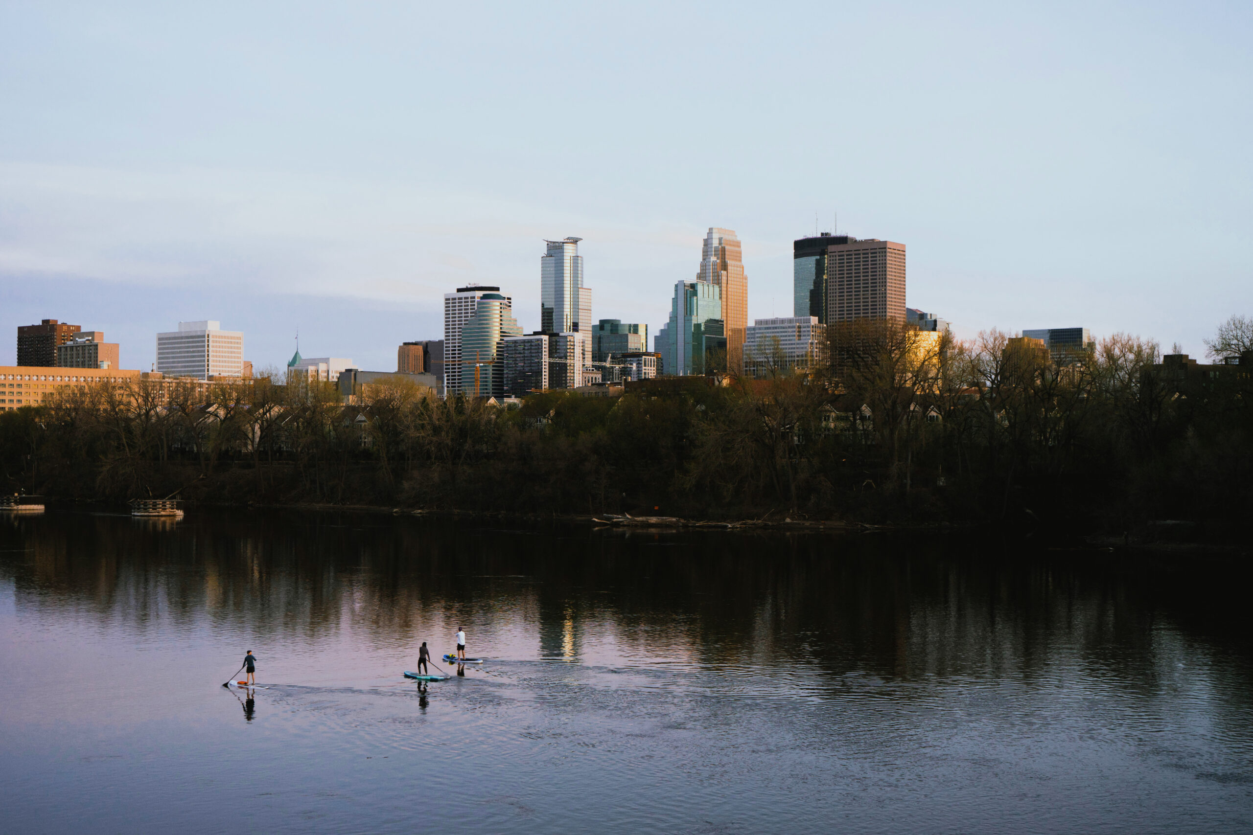 A photo of the Minneapolis skyline reflected on the Mississippi River.